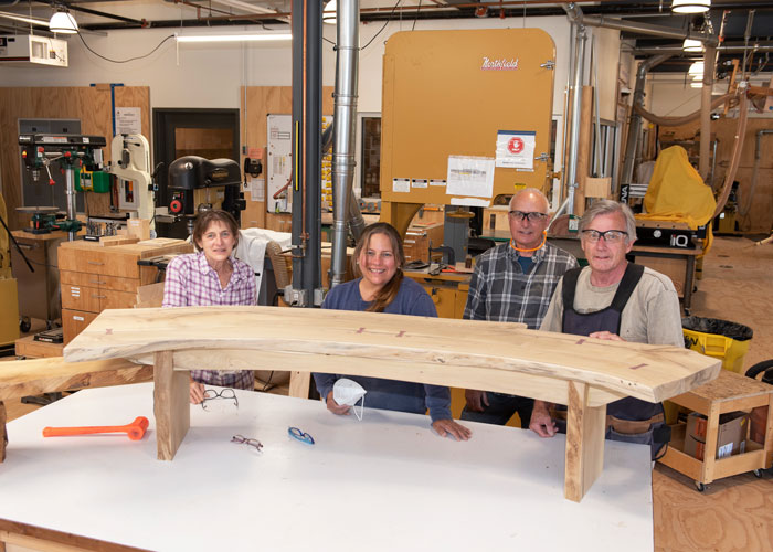 Woodworking Studio team with community service bench project