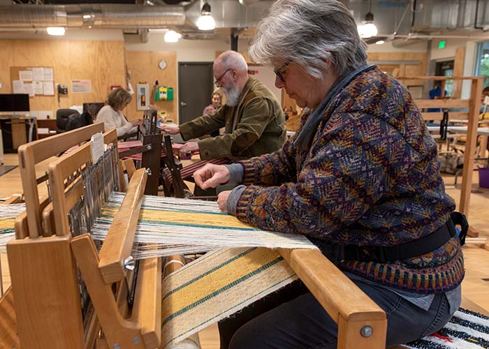 BARN members use the looms in Fiber Arts during Open Studio