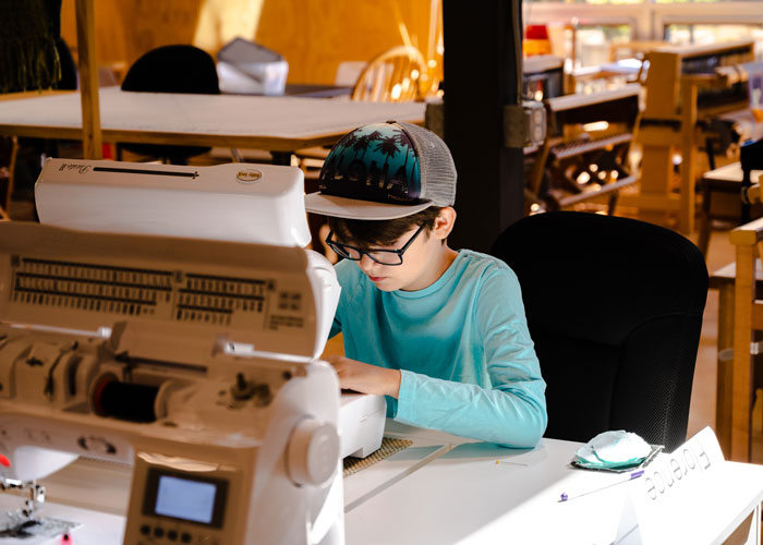 Young sewist at sewing machine at BARN