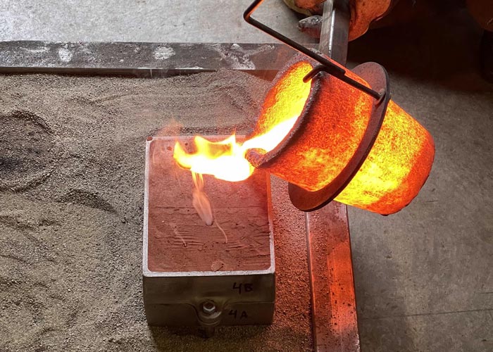 Molten metal being poured in a foundry casting class