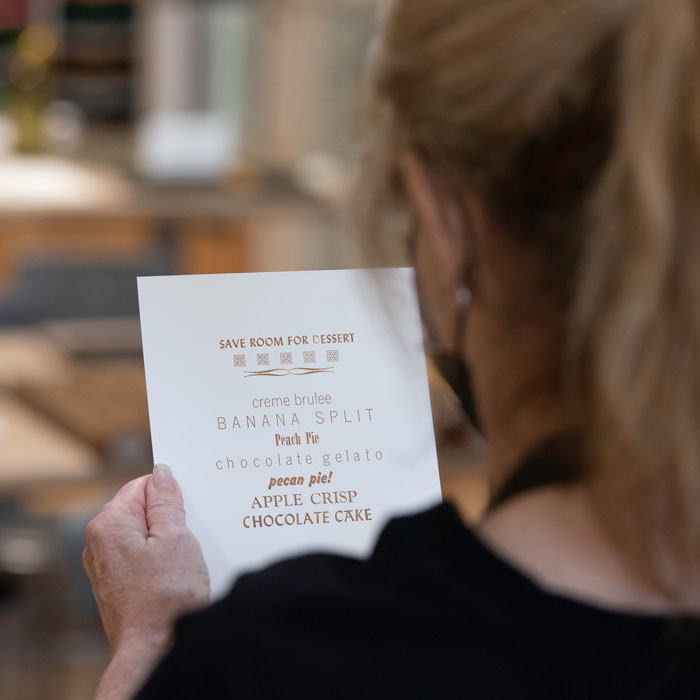 Person looking at menu printed on letterpress at BARN