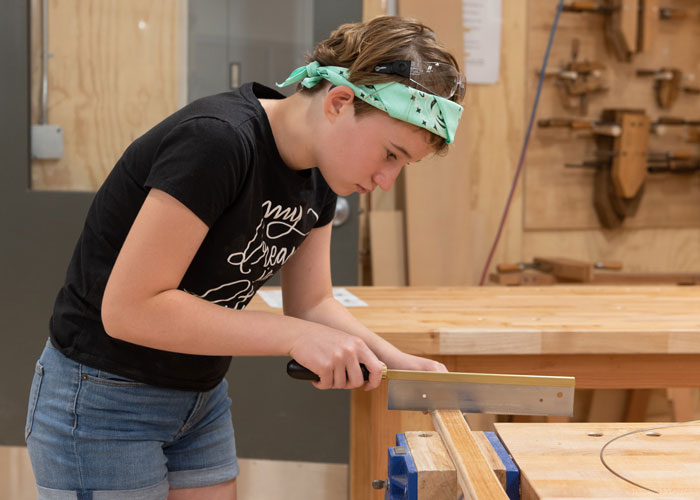 Youth working in Woodshop bench room