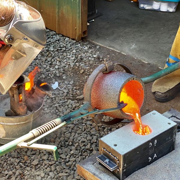 Pouring molten bronze into molds