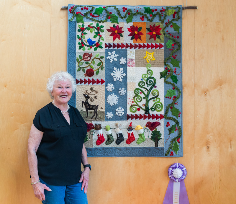Fiber Arts member Loretta Gordon with her award-winning quilt.
