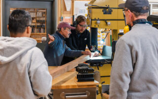 Woodworkers at work on library bench community service project.