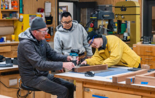 Woodworkers at work on library bench community service project.
