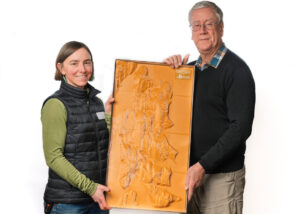 Megan Rohrssen from Bainbridge Island Land Trust with Keith LaPlain from BARN's Tech Lab holding a 3D map of Bainbridge Island