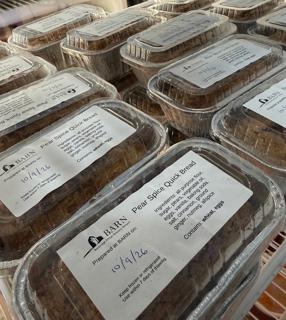 Rows of packaged mini loaves of spiced pear quick bread ready to go to the local food bank.